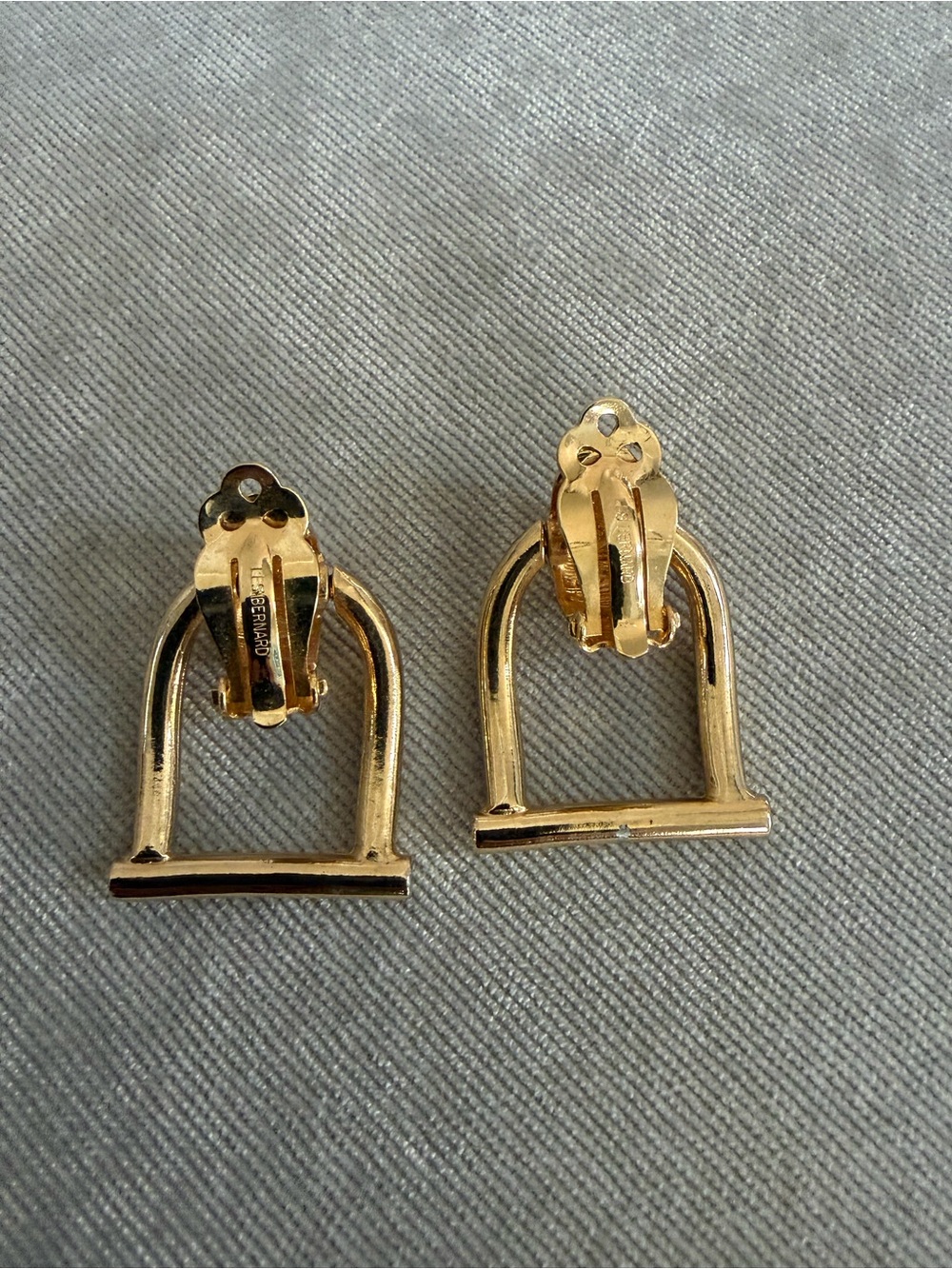 Gold-tone Archer Stirrup Clip-On Earrings.